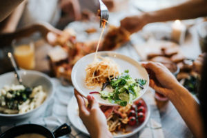 passing and sharing food across table